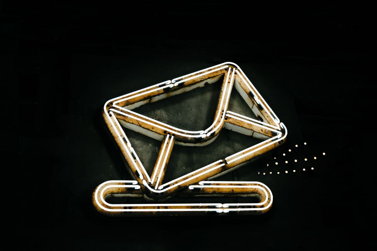 Neon envelope sign representing cold email outreach