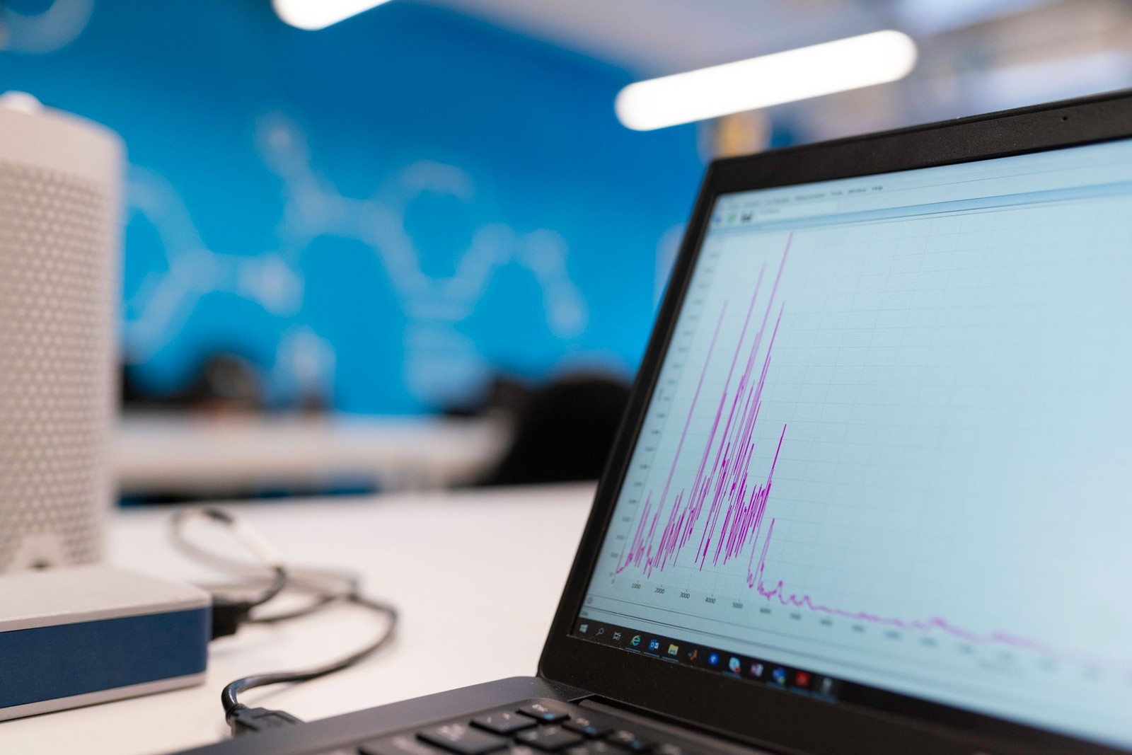 A laptop screen displaying a rising analytics growth graph