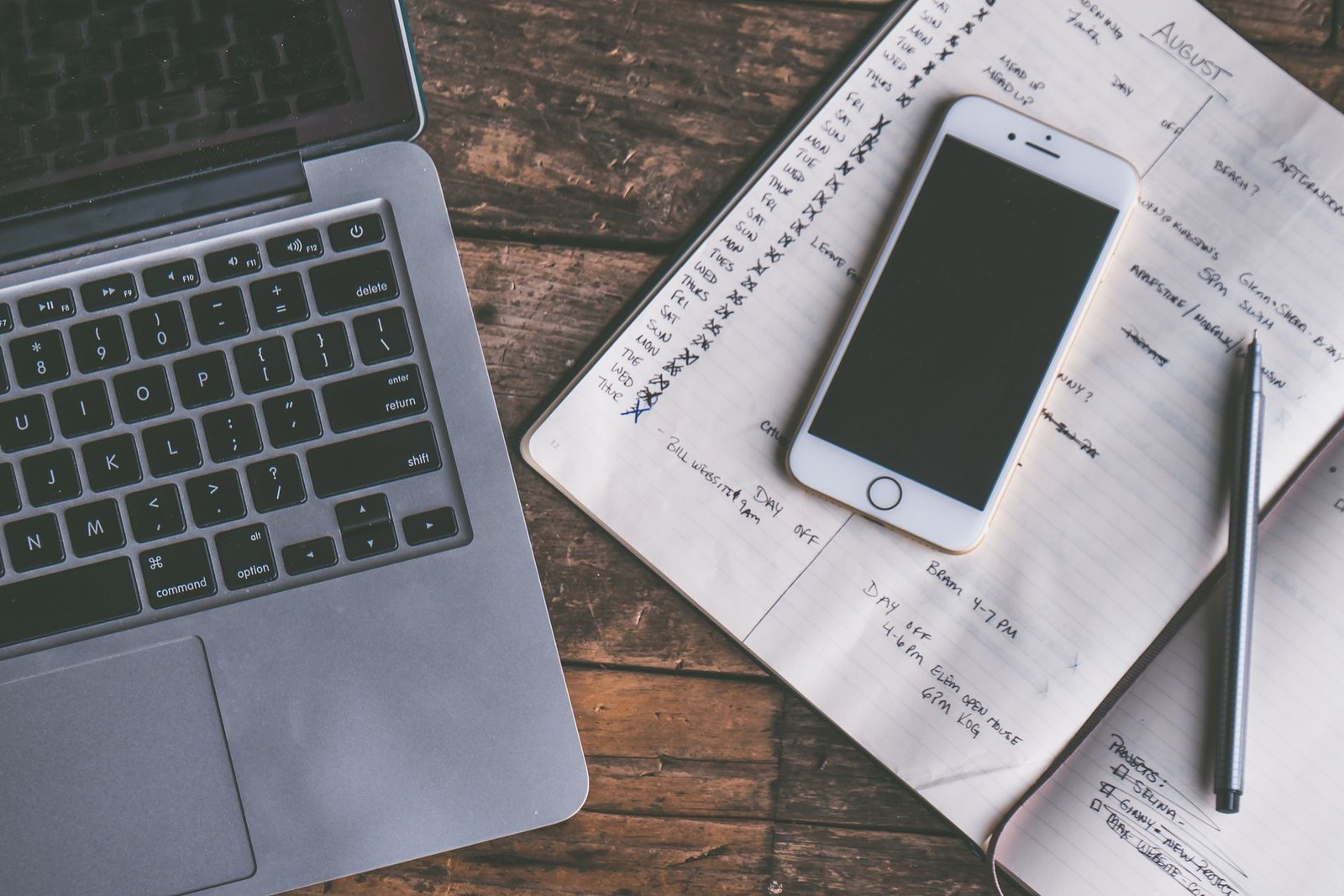 A laptop and a smartphone side by side on a desk