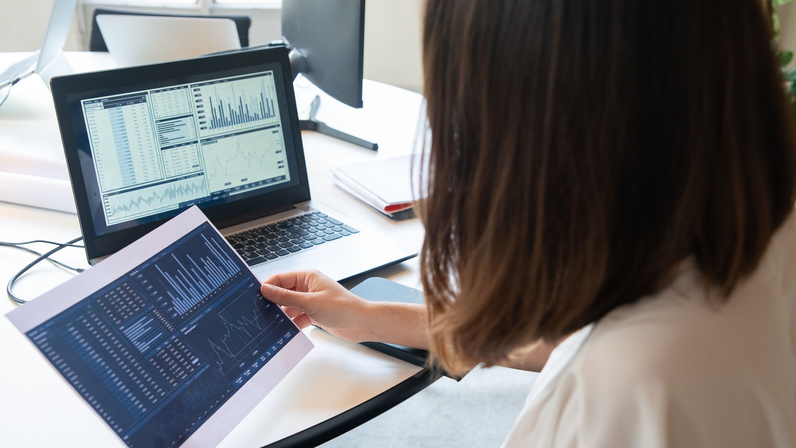 A person reviewing a website performance dashboard on a laptop screen
