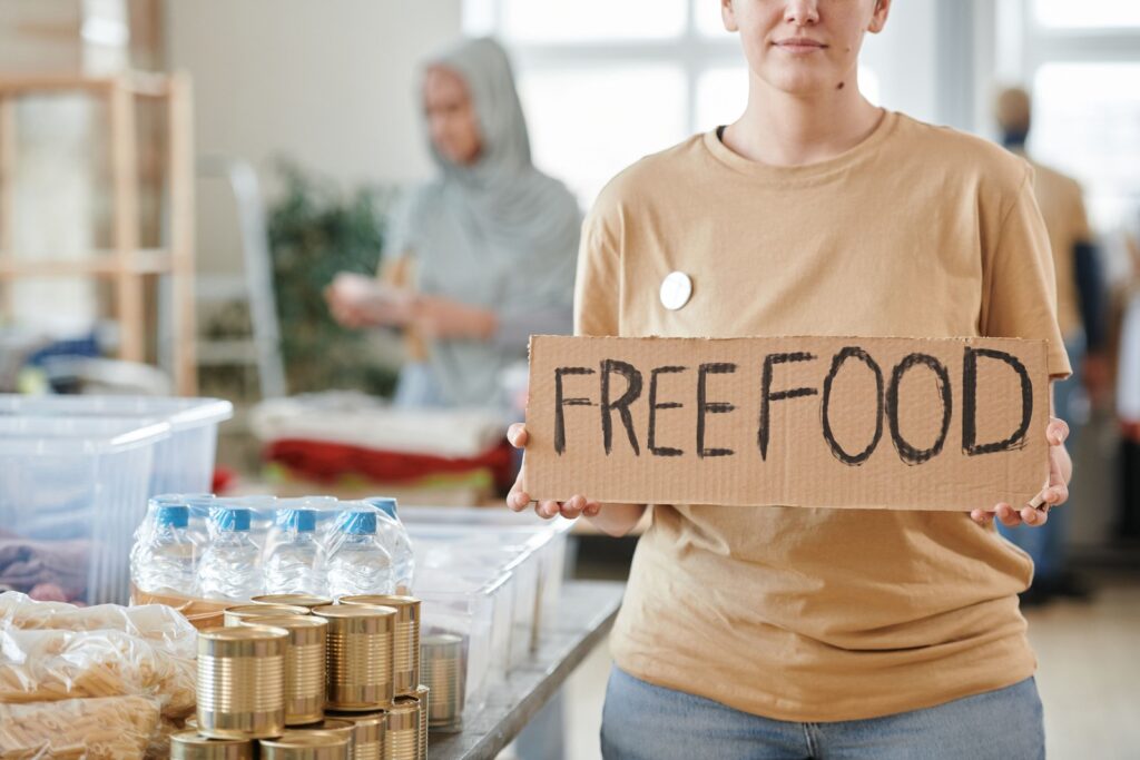 Volunteers handing out free food and water at a community outreach table